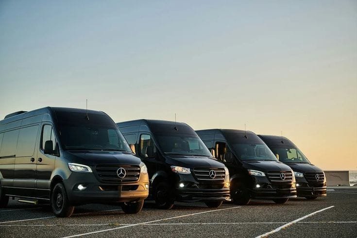 Fleet of black Shuttle Sprinter vans lined up